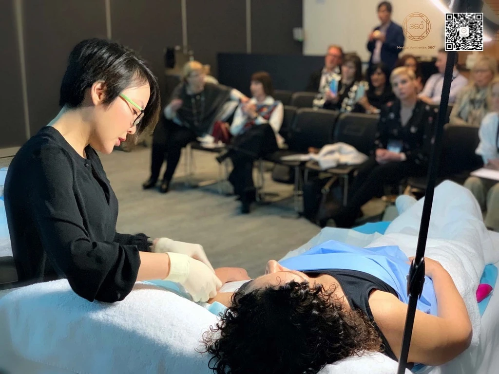 Dr Luo conducting a live workshop demonstration observed at close range by clinical professionals