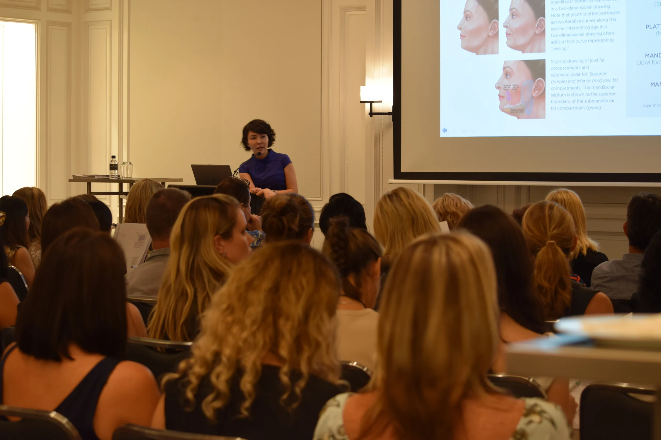 Dr Luo presenting facial assessment and relevant anatomy to a professional audience