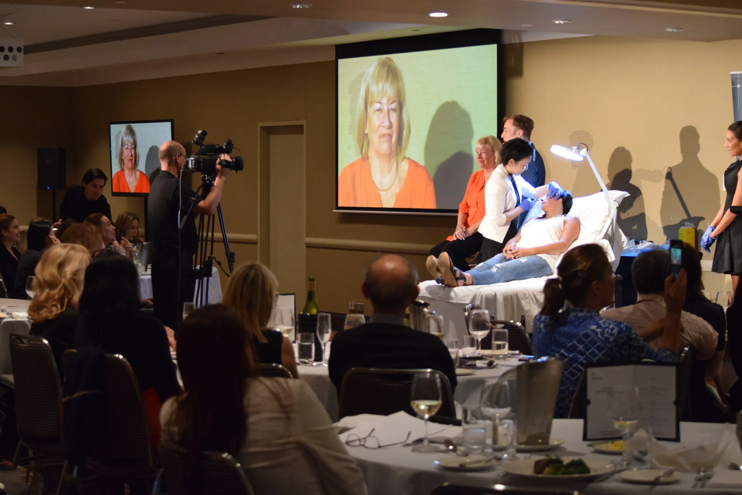 Dr Suzanna Luo performing a filmed live demonstration for clinicians during a dinner education event