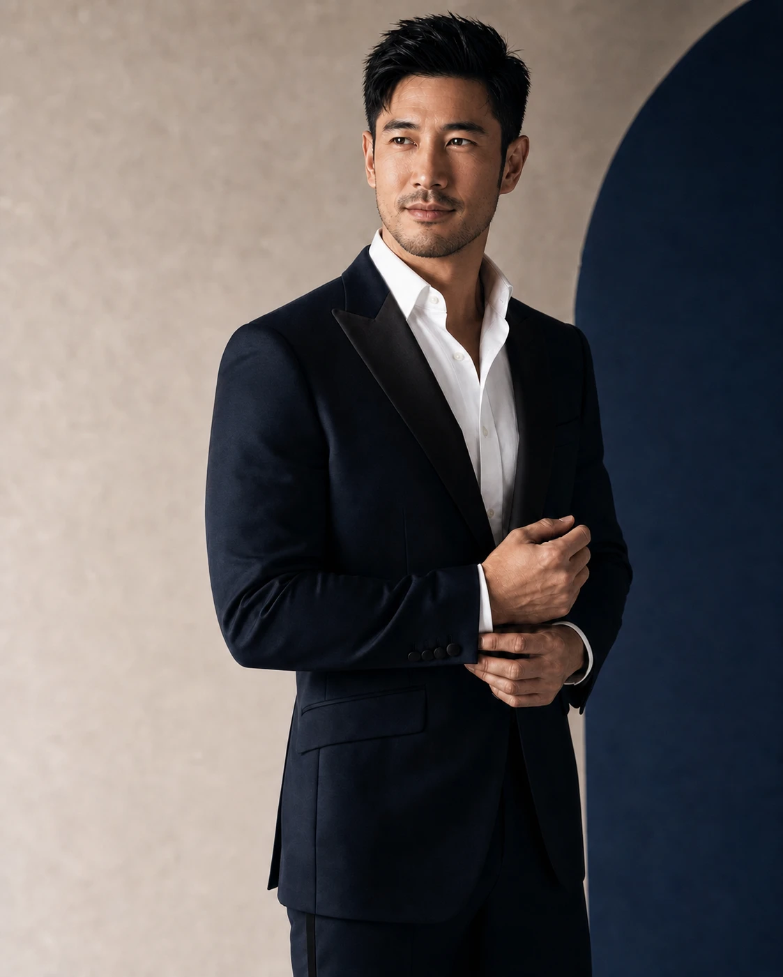 Man in his early thirties wearing a tailored midnight navy suit with a strongly defined jawline
